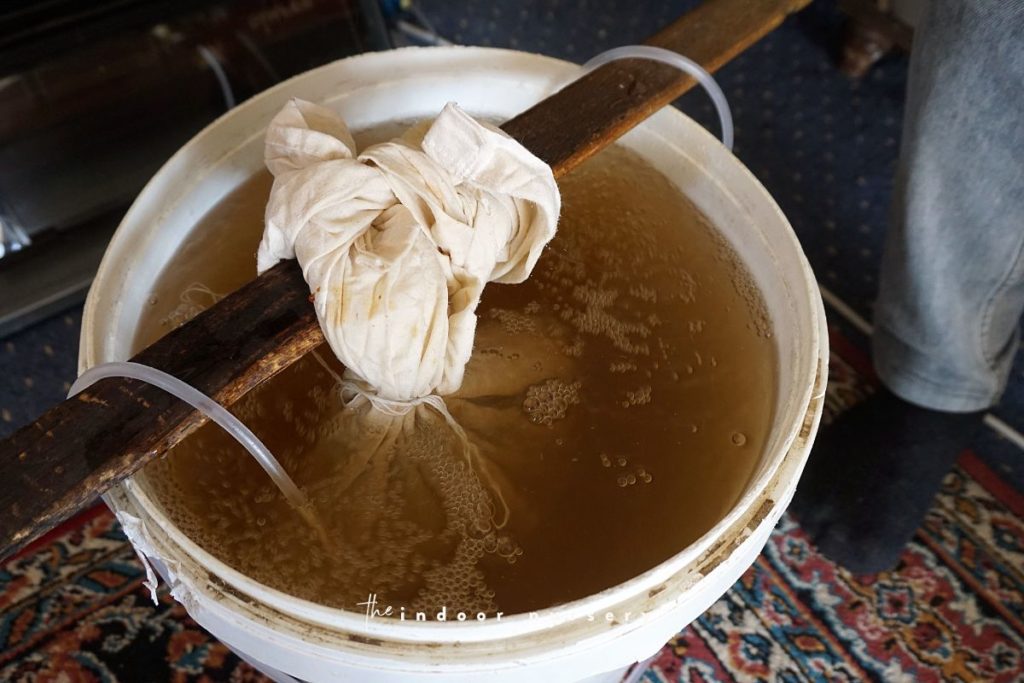 Making of worm tea in a white bucket